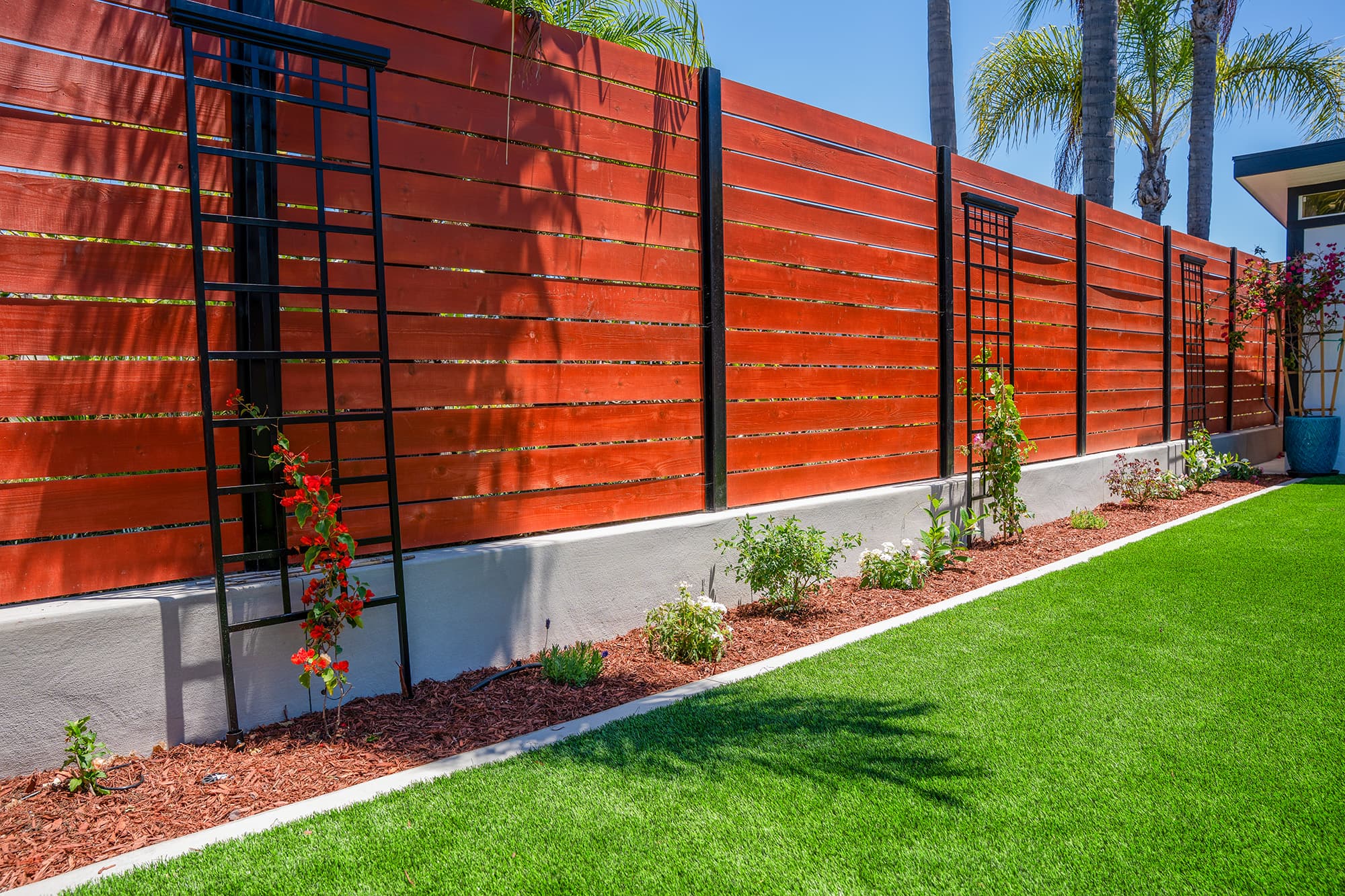 Backyard remodel with artificial turf, fence and landscaping