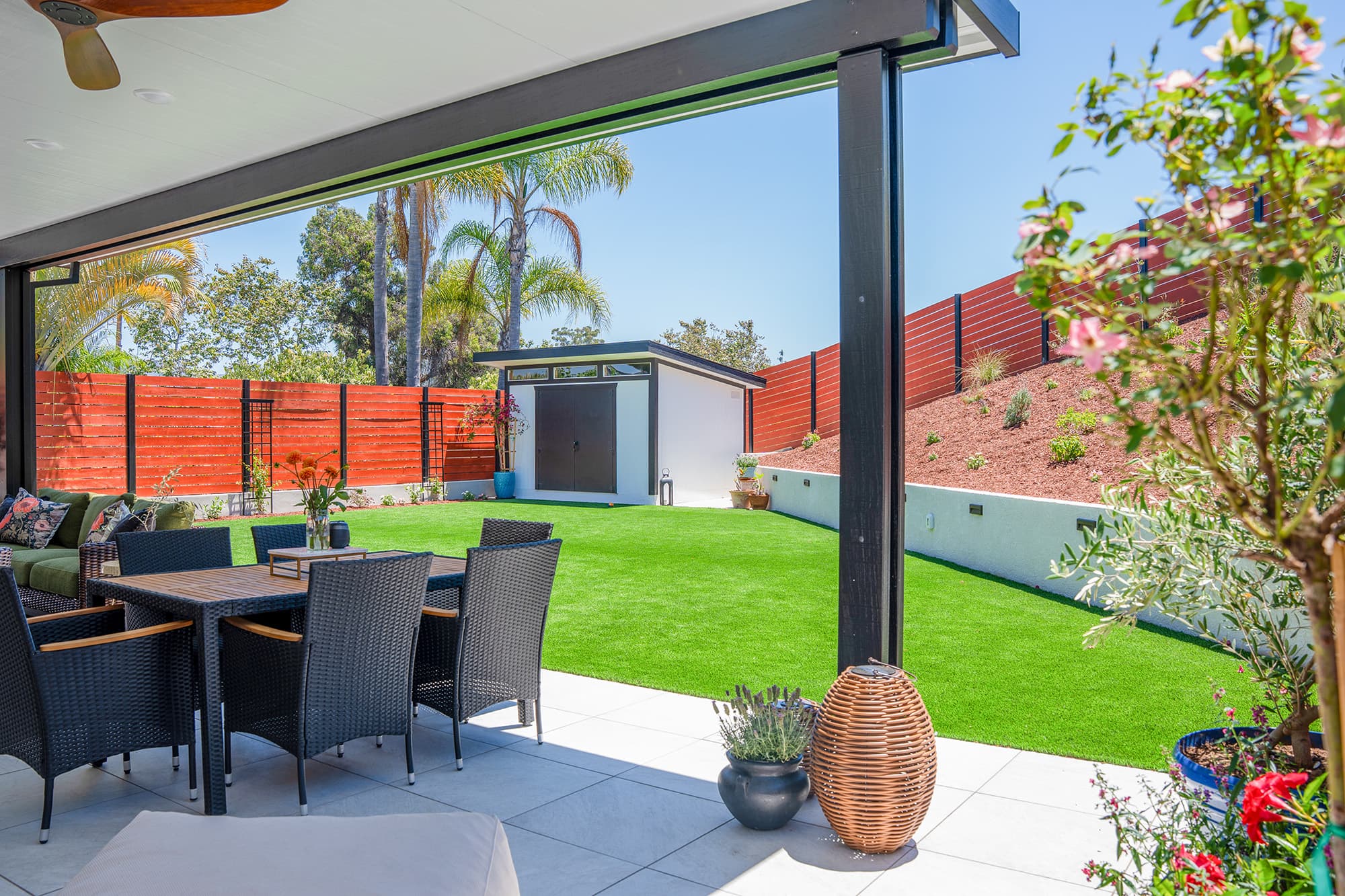 Backyard remodel with artificial turf, retaining wall and landscaping